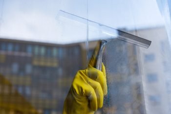 window cleaner cleans dusty window