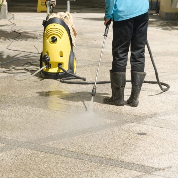 worker spraying the floor